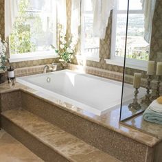 a bathroom with a large tub next to a sink and window in it's corner