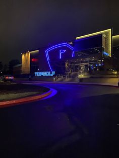 a building lit up with blue lights at night