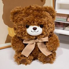 a brown teddy bear sitting on top of a table