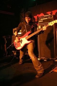 a man is playing guitar on stage