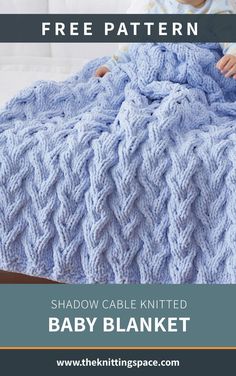 a baby laying in bed under a blue blanket with text overlay that reads, free pattern shadow cable knitted baby blanket