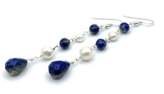 A pair of long earrings crafted with 925 sterling silver, blue lapis lazuli and freshwater white pearls. LENGTH:  3.3 inches - 8,3 cm - 6,5 gr. Drops : 13 x 11 mm MATERIALS: 925 Sterling Silver Lapis Lazuli Freshwater Pearls All jewellery is shipped in a working day with registered mail. If you require quick delivery, please consider our Express Shipping option. Free pouch drawstring bag with every order Sofia's Bijoux jewelry: http://www.etsy.com/it/shop/Sofiasbijoux More Earrings: https://www. Blue Sterling Silver Pearl Earrings As Gift, Elegant Lapis Lazuli Earrings With Natural Stones, Sterling Silver Blue Jewelry With Pearl Drop, Handmade Blue Pearl Earrings In Sterling Silver, Handmade Blue Sterling Silver Pearl Earrings, Elegant Lapis Lazuli Dangle Jewelry, Elegant Silver Earrings With Lapis Lazuli, Elegant Sterling Silver Pearl Earrings With Natural Stones, Elegant Silver Lapis Lazuli Earrings