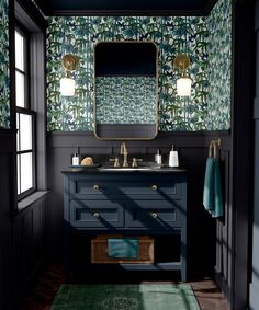 a bathroom with blue vanity and green wallpaper