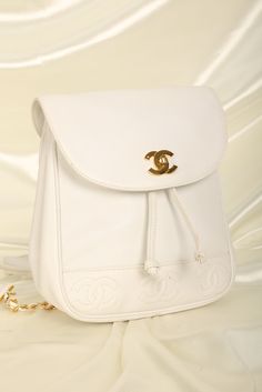 CONDITION: GOOD VINTAGE .??¨ Bringing to the shop a rare snow-white??¨Chanel caviar backpack with 24K plated gold hardware, and mini timeless logos on bottom of bag. Drawstring bucket for easy access. Perfect for festival season or travel! Spacious interior. 24K gold plated chain straps. Backpack currently going online for $3300-$6000. Crafted in 1994-1996 Please note: Minor glue reside along edges as shown in photos. Light hairline scratches on turnlock hardware. In order to meet the current demand and given the??¨nature of sourcing inventory, all sales are final. Please be sure to review all pictures and ask any questions prior to making a purchase! To prevent any form of fraud, I??¨keep video records of??¨myself??¨packaging??¨and dropping off each order, and??¨all??¨orders ship with??¨t Designer Backpack, Girl Backpacks School, Chanel Caviar, Backpack Tote Bag, Designer Backpacks, Girl Backpacks, Gold Plated Chains, Handbag Backpack, Chain Strap