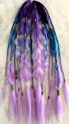 Purple Rain Festival Braids Extensions☔️Ombré royal purple, blue, and lilac hair with black and silver-colored hair charms throughout as well as amethyst-colored glass hanging hair gems 💎 💜 Pull-Through Braids, Fishtail Braids, Bubble Braids, Rope Braids, and Traditional Plaits On a hair tie for easy use. Wrap the loose hair section around a ponytail or bun and secure with a bobby-pin, or braid into your own hair for awesome and easy festival braids. See my instagram @braidsbabes88 for installation tutorials 🥰😻 DisclaimerThis is sold as a single set for a ponytail. If you want 2 separate sets for pigtails as shown in some of the photos, a quantity of 2 must be purchased**There are only 2 in stock, if a single set is purchased, this disclaimer and the listing photos will be updated to r Braids Fishtail, Braids Extensions, Festival Braids, Rope Braids, Bubble Braid, Fishtail Braids, Hair Charms, Pull Through Braid, Bubble Braids