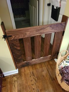 a basket full of stuff sitting on the floor next to a wooden door with a mirror behind it