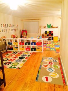 a child's playroom with lots of toys and rugs on the floor