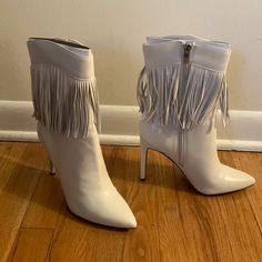 Brand New, Never Worn 7.5 Tries Heeled Fringed Ivory Booties. Fringe All Around Boots With Silver Zipper. 4 Inch Heel Height. Will Ship With Box White Heeled Boots For Spring Party, Chic Off White Boots For Fall, White Closed Toe Booties For Party, Chic Cream Heeled Boots For Party, Chic White Heeled Boots For Party, White Boots With 4-inch Heel And Round Toe, Chic White Heeled Boots, Medium Width, Chic White Heeled Boots Of Medium Width, Chic White Heeled Boots Medium Width