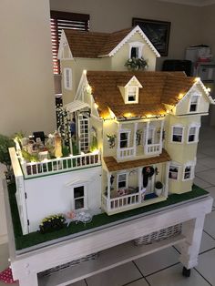 a doll house with lights on top of it