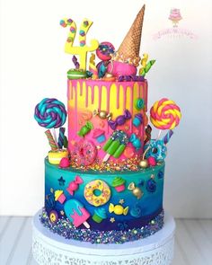 a multi layer cake decorated with candy and candies