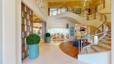 a staircase leading up to a living room and dining room