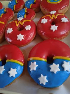 there are many decorated doughnuts on the tray with stars and superman symbols in them