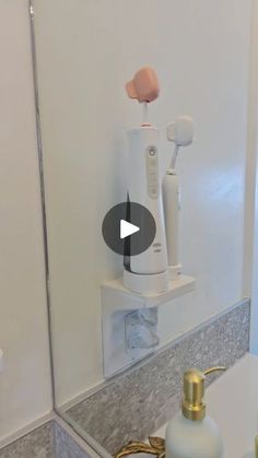 a bathroom mirror with toothbrushes and soap dispenser on it's side