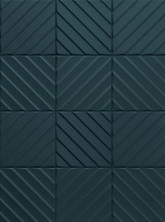 a black tile wall with diagonal lines on it