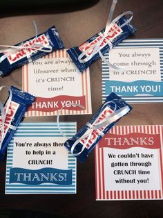 some candy bars are sitting on a table with thank you tags attached to the wrappers