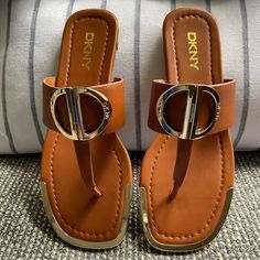 1/2" Heel With A Round-Toe Thong Slip-On Flat Sandals. D-Ring-Style Hardware Trim At Instep Band; Metallic Accents At Toe And Heel. Color: Dark Cognac Dkny Shoes, Ring Style, Toe Rings, Metallic Accents, Flat Sandals, Women's Shoes Sandals, Cognac