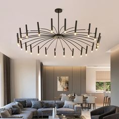 a living room filled with furniture and a chandelier hanging from the ceiling above it