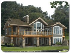 this is an artist's rendering of a house in the country side with stone and wood accents