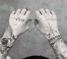 a man with tattoos on his arms and wrist