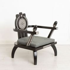 a black chair with a gray cushion on it