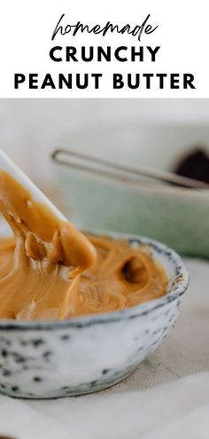 homemade crunchy peanut butter in a bowl with a spoon scooping out the peanut butter