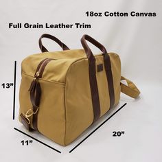 Beautiful, Rugged Harvest Tan 18oz Cotton Canvas Travel Bag with commercial water repellent finish and Full Grain Leather Handles and Trim. It's comfortable in the hand or over the shoulder. Will carry your things in style. Durability that will last.Size:20" wide x 13" height x 11" depth2" Wide adjustable shoulder strapMaterials:18oz Durable Cotton Canvas with commercial water repellent finish and Full Grain Leather TrimMade in the U.S.A.PROCESSING TIME:Your item will ship within 1-5 business da Canvas Travel Bag, Leather Bookmark, Gold Monogram, Unique Bags, Best Bags, Leather Handles, Weekender Bag, New Bag, Full Grain Leather