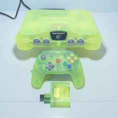 a neon green nintendo wii game controller and charger