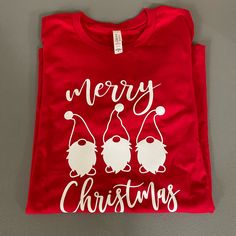 Merry Christmas Red Gnome Graphic T-Shirt Bella Canvas 100% Cotton Crewneck Tee Handmade With Heat Transfer Vinyl Red Cotton T-shirt For Holiday, Red T-shirt With Sublimation Print And Relaxed Fit, Red Holiday Graphic Tee Tops, Casual Red T-shirt With Heat Transfer Vinyl, Red Relaxed Fit T-shirt For Christmas, Heat Transfer Vinyl, Red Christmas, Bella Canvas, Red And White