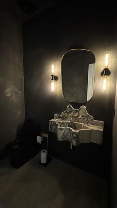 a bathroom with a sink, mirror and lights on the wall in front of it