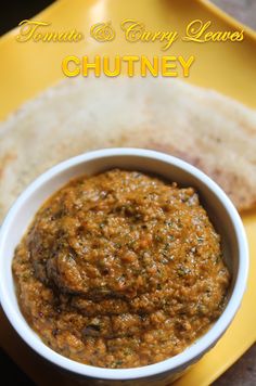 a small white bowl filled with chutney next to pita bread on a yellow plate