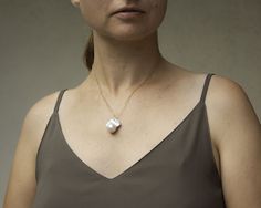 "This genuine Freshwater Baroque Pearl Necklace is absolutely stunning. This large white Pearl has an incredible rich luster. Baroque pearls are pearls with an irregular non-spherical shape. Shapes can range from minor aberrations to distinctly ovoid, curved, pinch, or lumpy shapes. Most cultured freshwater pearls are baroque because freshwater pearls are mantle-tissue nucleated instead of bead nucleated. Pearl measures around 1\" long. Each pearl has a unique natural shape, no two pearls are go White Baroque Pearl Necklaces For Gifts, White Baroque Pearl Necklace For Gift, White Baroque Pearl Necklaces As Gift, Unique White Baroque Pearl Jewelry, Unique Pearl White Necklace As Gift, Unique Pearl White Necklace For Gift, Unique White Pearl Pendant Necklace, High Luster Baroque Pearl Necklace Gift, Unique White Necklace With Pearl Pendant