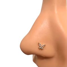 the side view of a woman's nose with a small diamond butterfly on it