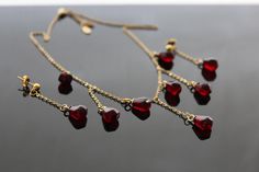 This exquisite jewelry set is inspired by the vibrant red hues of pomegranate seeds, embodying both delicacy and elegance. The set includes a necklace and matching earrings, meticulously crafted from 18K gold-plated stainless steel, offering both durability and a luxurious finish. Necklace: The necklace features a refined chain measuring 16 inches, with an additional 2-inch extension for adjustable wear. Its minimalist link design adds a touch of sophistication, making it a versatile piece for any occasion. Earrings: The earrings, measuring 1.5 inches in length, create a graceful drop effect that beautifully complements the necklace. Each earring is adorned with a glass bead resembling a pomegranate seed, adding a vibrant pop of color and an elegant focal point. The inclusion of red resin Link Design, Long Drop Earrings, Pomegranate Seeds, Resin Beads, Threader Earrings, Exquisite Jewelry, Vibrant Red, Matching Earrings, Pomegranate