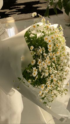 a bouquet of daisies and other flowers on a table