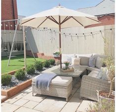 a patio with an umbrella and furniture on it