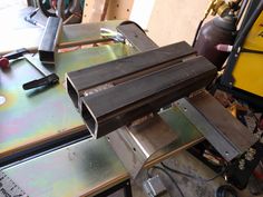 some metal pieces are being worked on in a shop