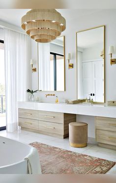 a large bathroom with two sinks and mirrors