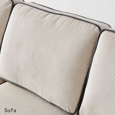 a close up of a couch with two pillows on it's back and side