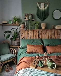 a bed room with a neatly made bed and lots of plants on the headboard