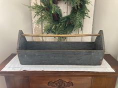 an old wooden chest with a wreath on top