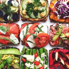 many different types of food are arranged on toasted breads with vegetables and other toppings