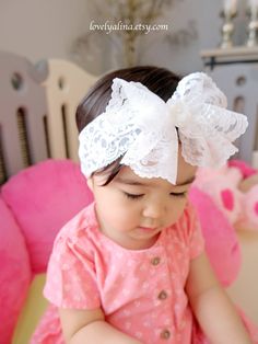 A beautiful lace bow headband suitable for all ages! Bow is approximately 5" wide attached to a 2" wide stretch lace. Offering different kinds of gem at the center of the bow to create a a diverse look.  Currently, photos are showing gem #1 and #2.  ⭐️Please note, gem sizes are different, therefore the result of the overall bow look may be slightly different than in photos. Also, due to the nature of this bow type, the shape/drape may slightly vary as well. Bow may look bigger in photos due to t Adjustable White Lace Hair Accessories, White Matching Headband For Baptism, White Adjustable Hair Accessories, White Hair Accessories With Matching Headband For Baptism, White Lace Headband For Party, White Lace Party Headband, Cute Adjustable Headband For Wedding, Cute Adjustable Headband For Weddings, White Bow Headband For Wedding