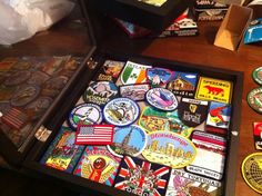 an open box filled with lots of different types of stickers on top of a wooden table