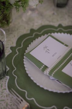 a green and white place setting on a table