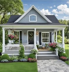 a small house with flowers on the front porch