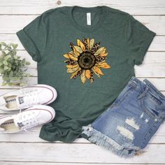 Our shirts are handmade in Ohio by hand with love and care one at a time.We hope you will find a shirt that will inspire you or someone else.DESCRIPTION:Sunflower, Sunflower Shirt, Floral Tee, Sunflower Tee, Womens Tshirts, Boho Shirt, Leopard Sunflower Tshirt, Summer Shirt, Flower ShirtThis cute daisy tee is a must. We use a high-quality unisex t-shirt that is insanely soft. In fact, it will be one of the softest, best-fitting, most comfortable shirts you’ve ever owned. CLICK BELOW 👇👇👇👇👇👇 Summer Casual T-shirt With Sunflower Print, Trendy Green Floral Print Shirt, Summer Crew Neck T-shirt With Plant Print, Trendy Short Sleeve Shirt With Plant Print, Trendy Crew Neck Shirt With Plant Print, Relaxed Fit Graphic Tee With Plant Print, Summer Sunflower Print Crew Neck Top, Summer Graphic Tee With Plant Print, Green Letter Print Shirt For Spring