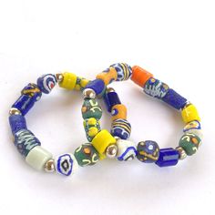 African bracelets with traditional, authentic Krobo beads, ethnic glass beads from Ghana in colorful hues. These handcrafted beads give this bracelet a unique and timeless character, ethnic and colorful, a great gift idea. All African beads are 100% handmade by Ghanaian artisans (fair trade). Krobo beads have a rich history, used for centuries in traditional West African jewelry.  Glass beads (Krobo land - Ghana) are made from recycled glass powder, bottles and other glass objects that are transformed into powder, then into molds to create these beautiful beads. Sizes range from 9 to 12 mm in diameter. Very limited series - Only 2 unique models to choose from here. These handcrafted pearls give this bracelet a unique, timeless character. Your bracelet will be identical to the bracelets pic