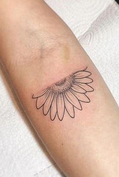 a black and white photo of a sunflower on the arm