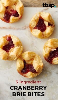 cranberry brie bites on a marble slab with text overlay that reads 3 ingredient cranberry brie bites