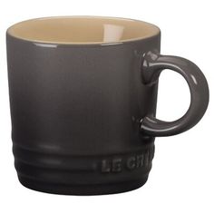 a black and tan coffee cup on a white background